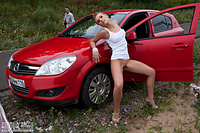 Girl posing near car